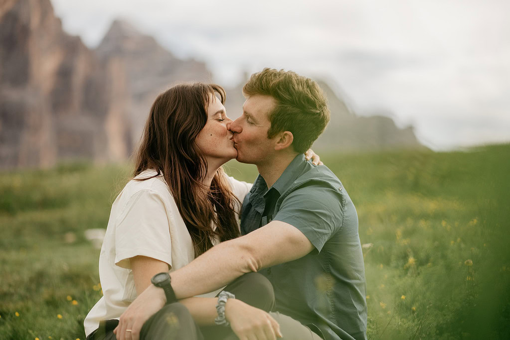 Couple kissing outdoors in a meadow