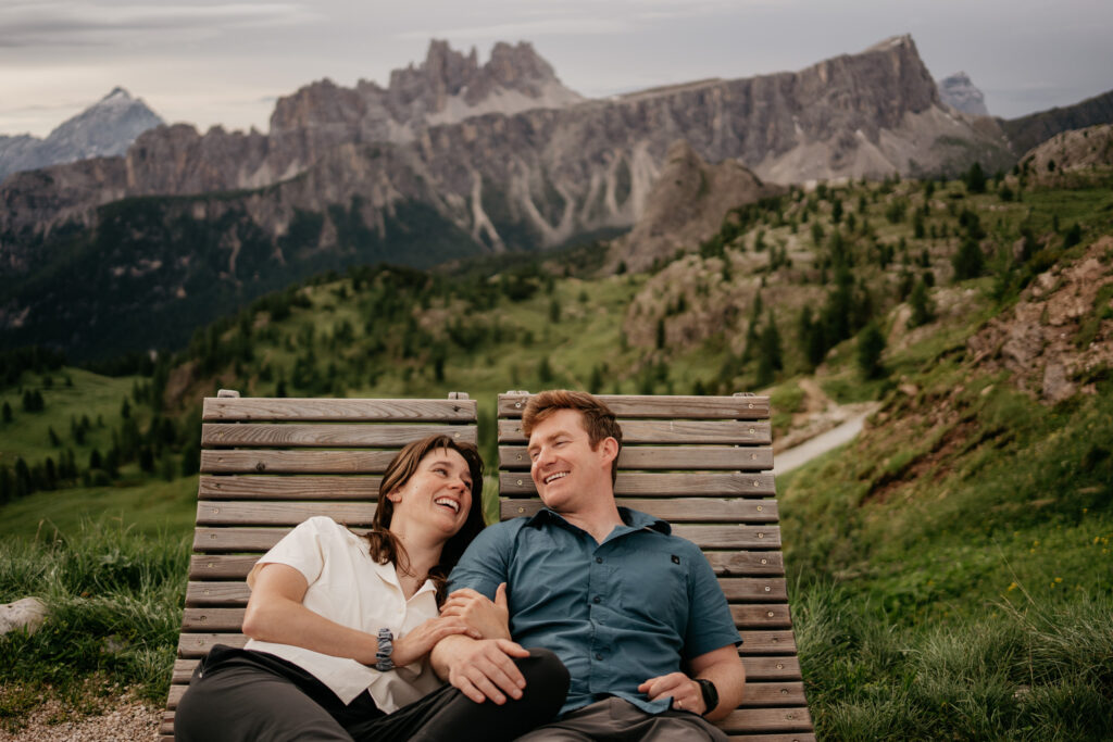 Couple lounging with mountain view background.