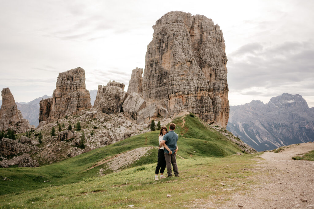 Couple embracing in mountainous landscape.