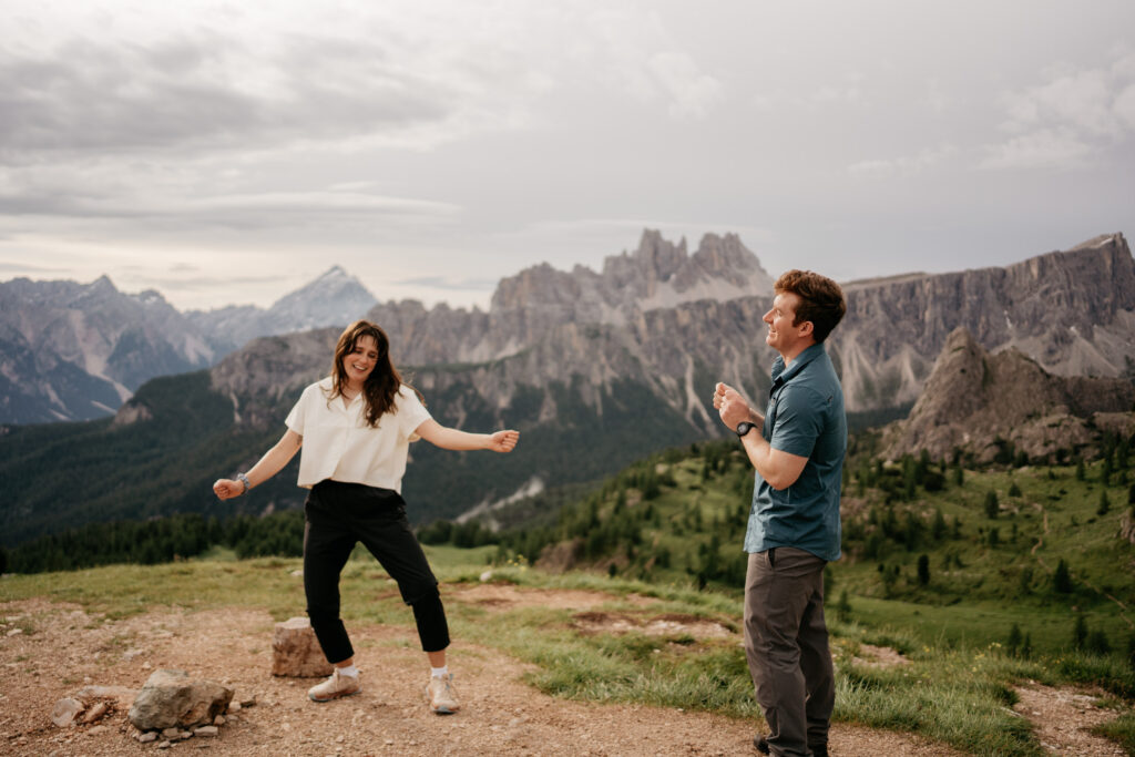 Couple enjoying mountain view and dancing happily.