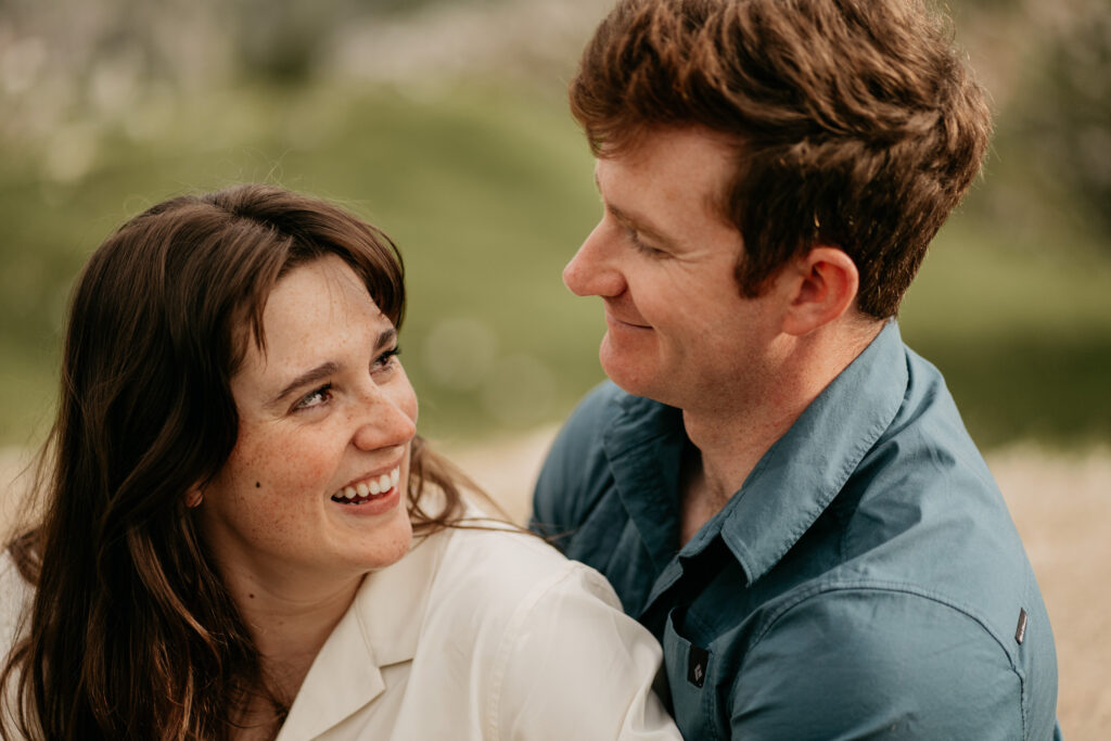 Smiling couple looking at each other outdoors