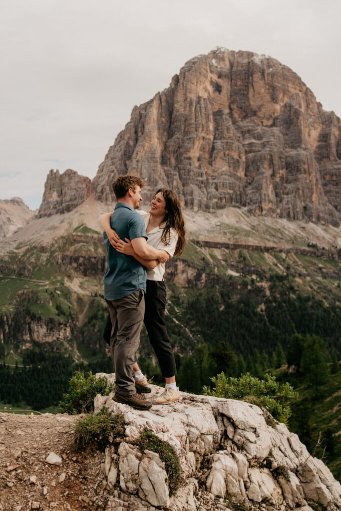 Couple embracing on mountain summit view.