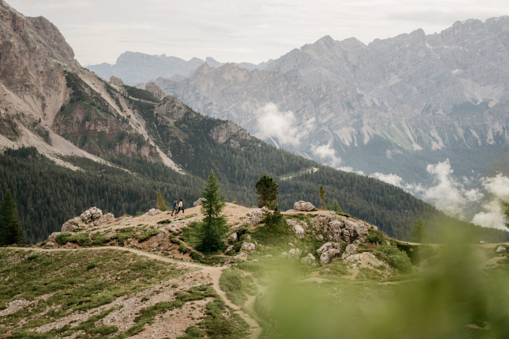 Hiking in mountain landscape with cloudy sky.