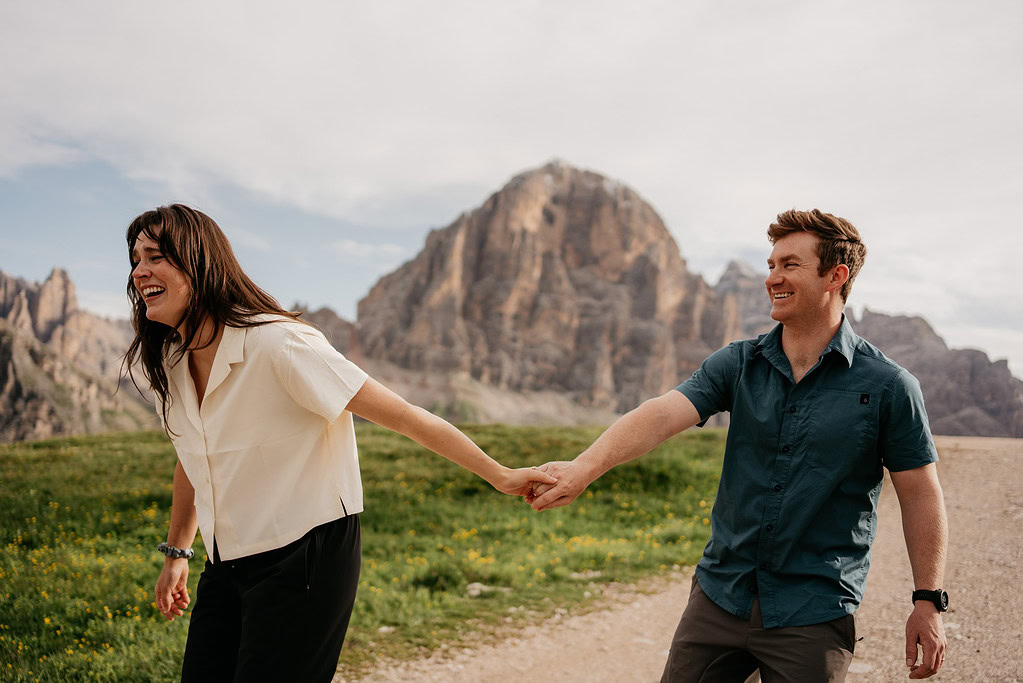 Couple holding hands in mountain landscape