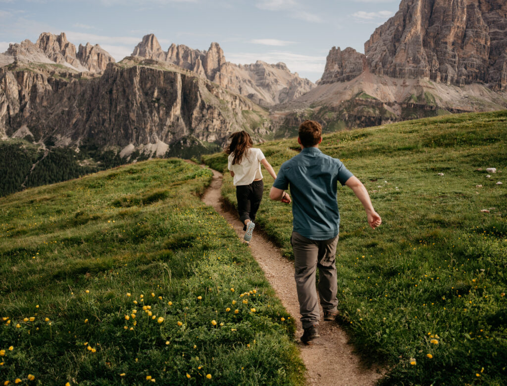 Couple hiking through scenic mountain landscape.