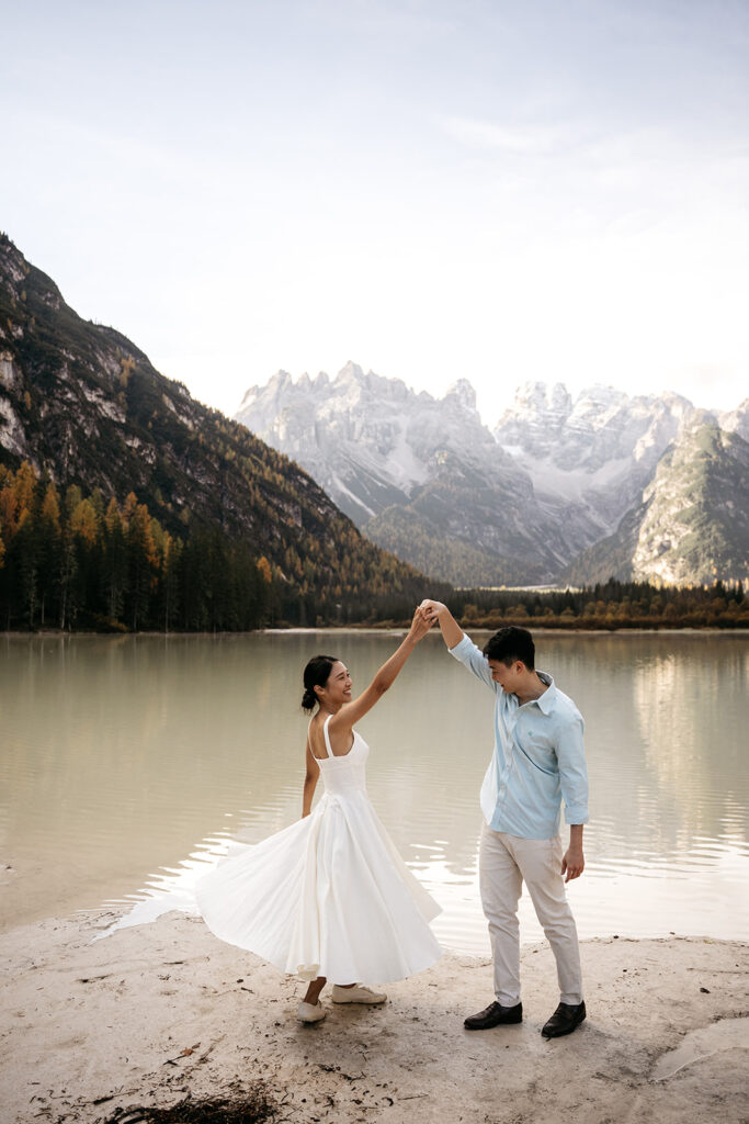 Couple dancing by a mountain lake.