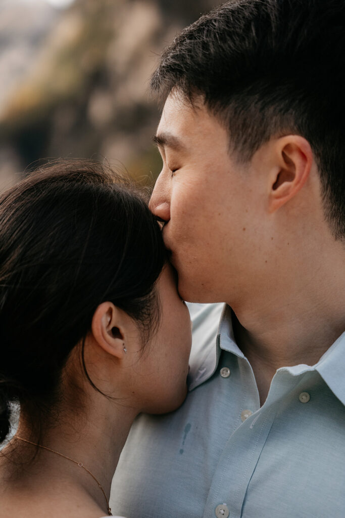 Couple sharing a tender, intimate moment outdoors.