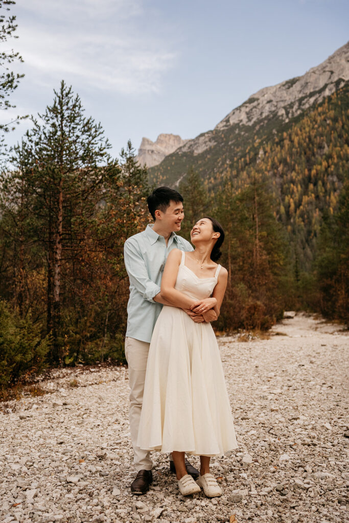 Couple embracing on rocky mountain path