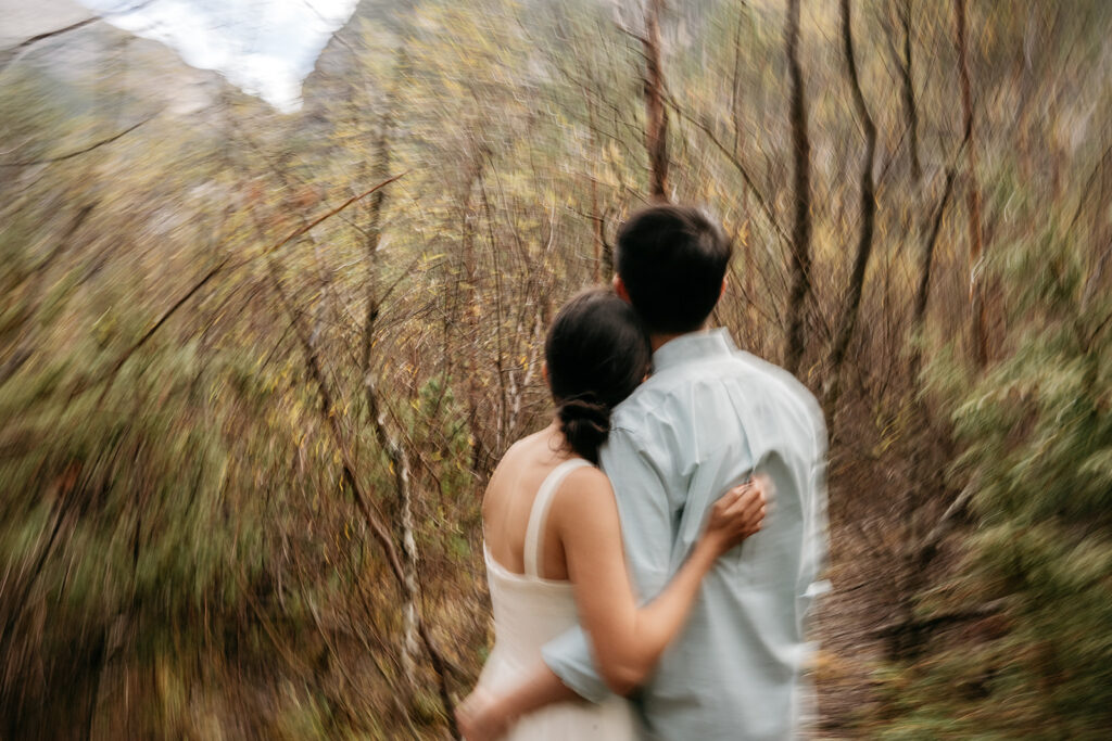 Couple embracing on forest path