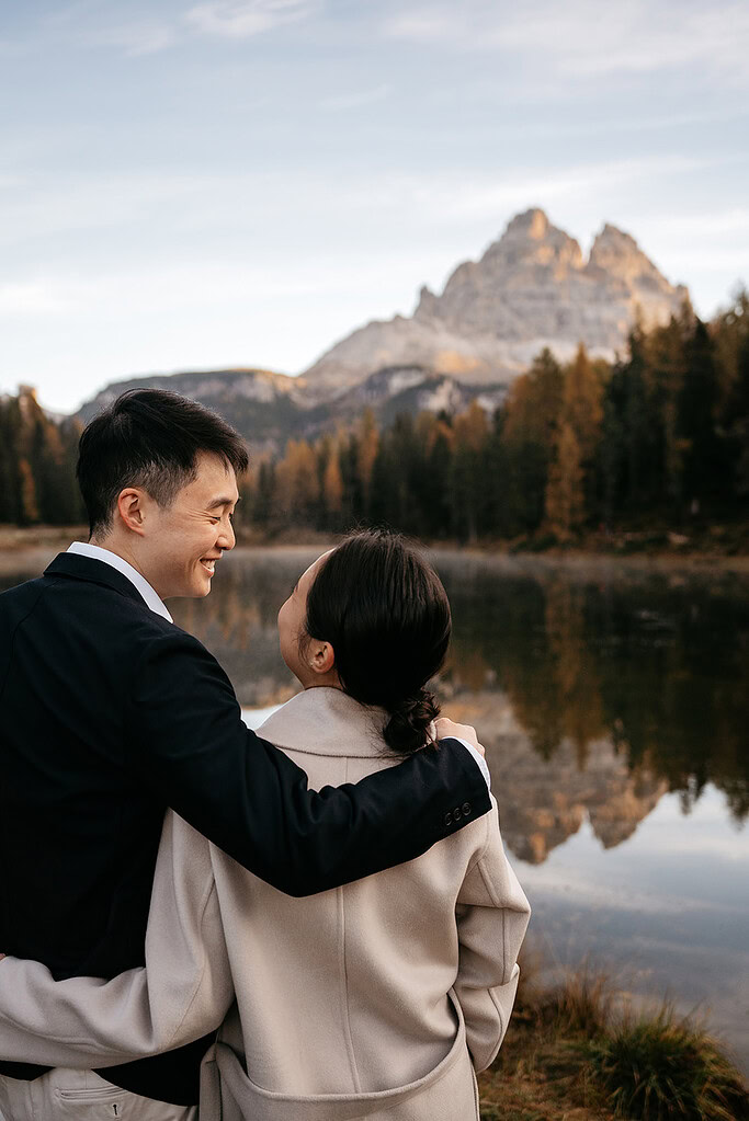 Couple embraces by scenic mountain lake view