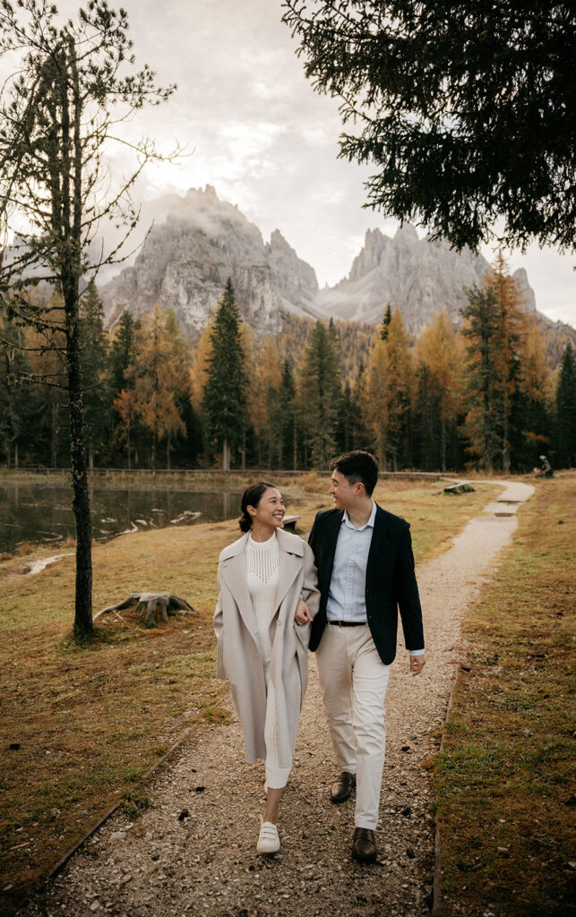 Couple walking on mountain path in autumn