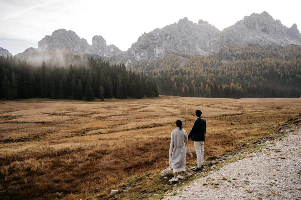 Couple enjoying mountain view in autumn landscape.