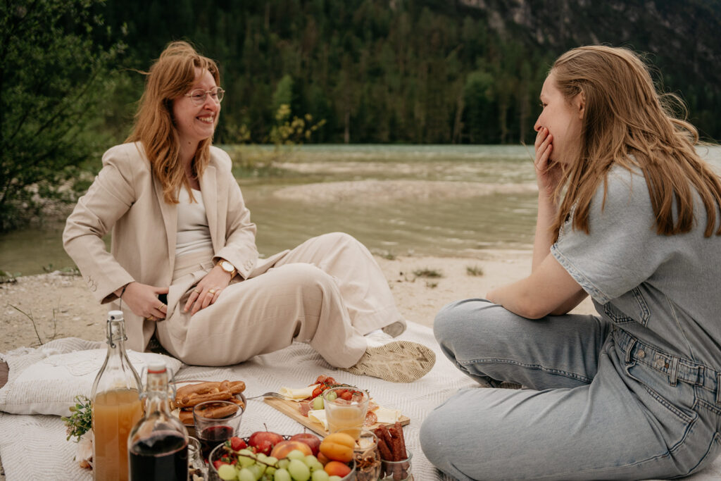 Two friends enjoying a picnic by the lake.