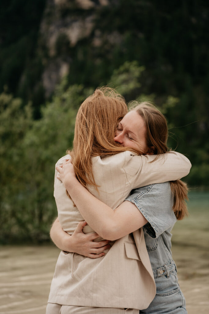 Two people hugging outdoors, showing affection.