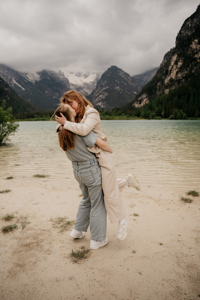 Couple hugging by mountain lake