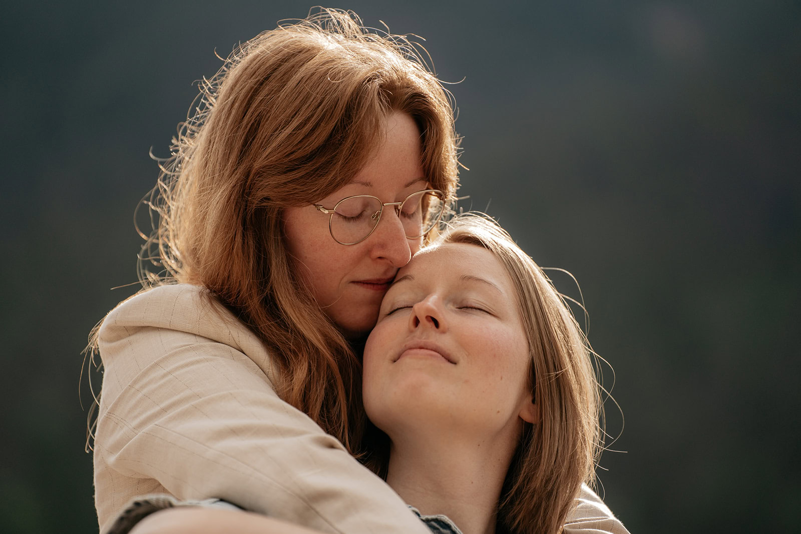 Two friends embracing peacefully outdoors.