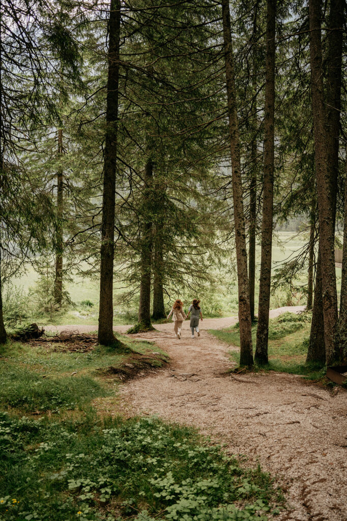 Two people walking on forest path