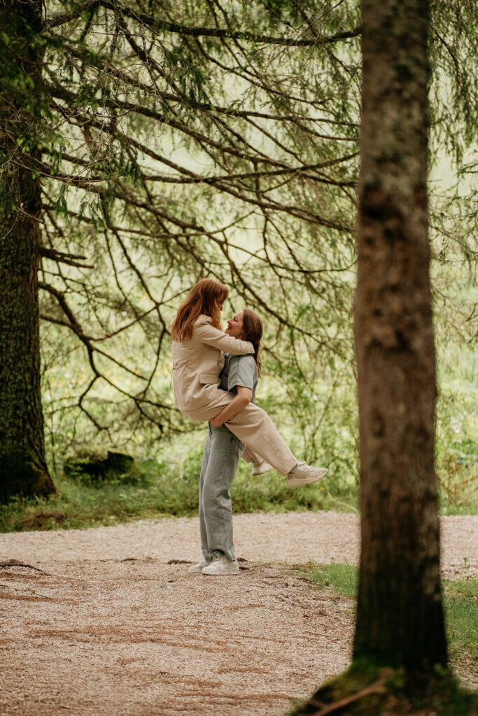 Couple embracing in forest clearing