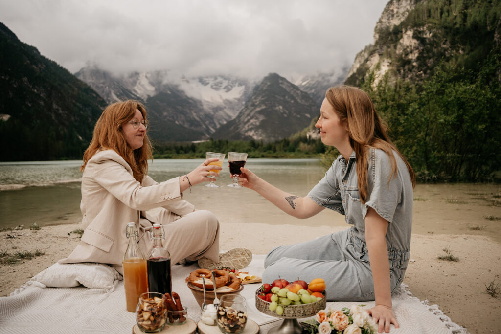 Friends enjoying picnic by mountain lake