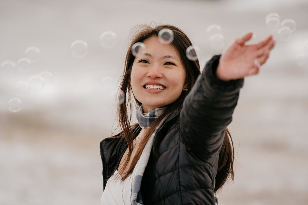 Smiling woman reaching out in winter jacket