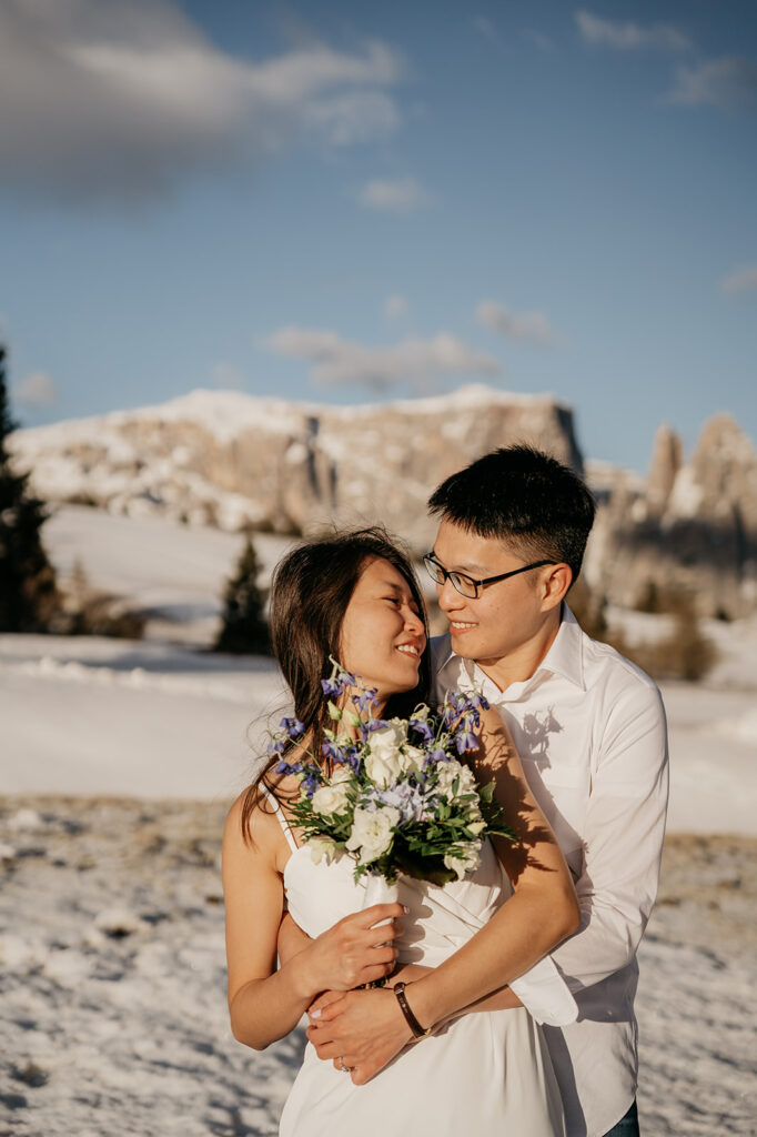 Couple embracing in snowy mountain landscape