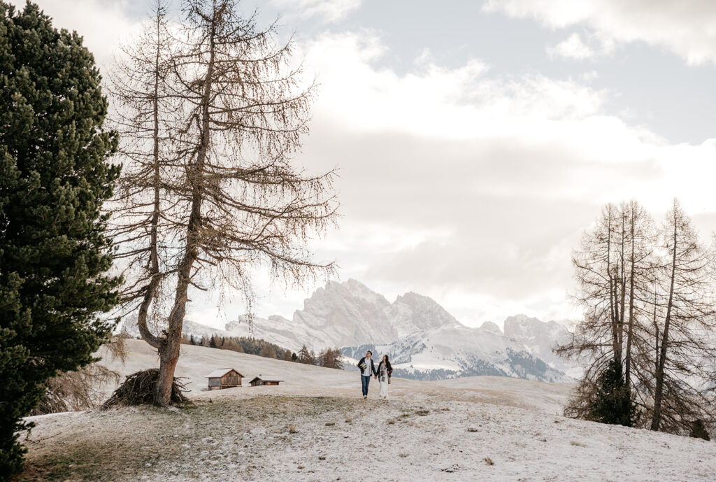 Couple walking in snowy mountain landscape