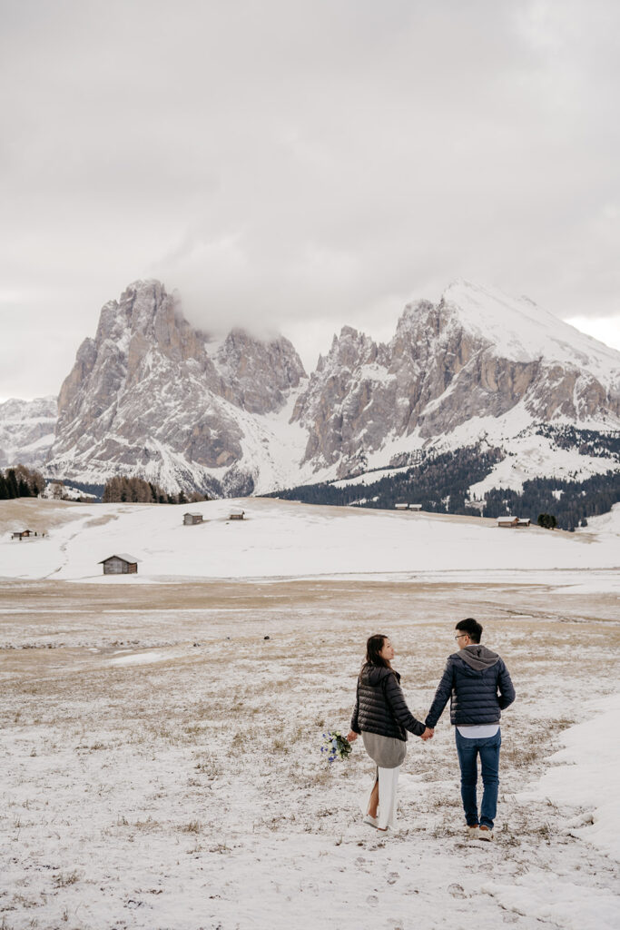 Couple walking on snowy mountain landscape