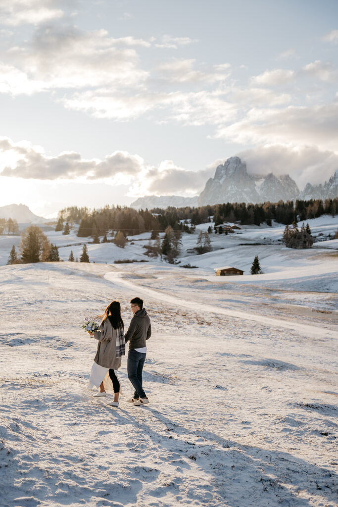 Couple walking on snowy mountain landscape