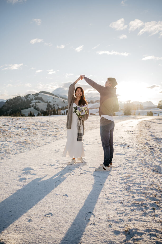 Couple dancing on snowy mountain landscape