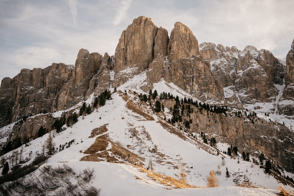 Snowy mountain peak under a cloudy sky.