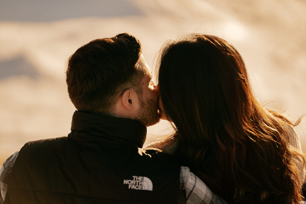 Couple kissing at sunset