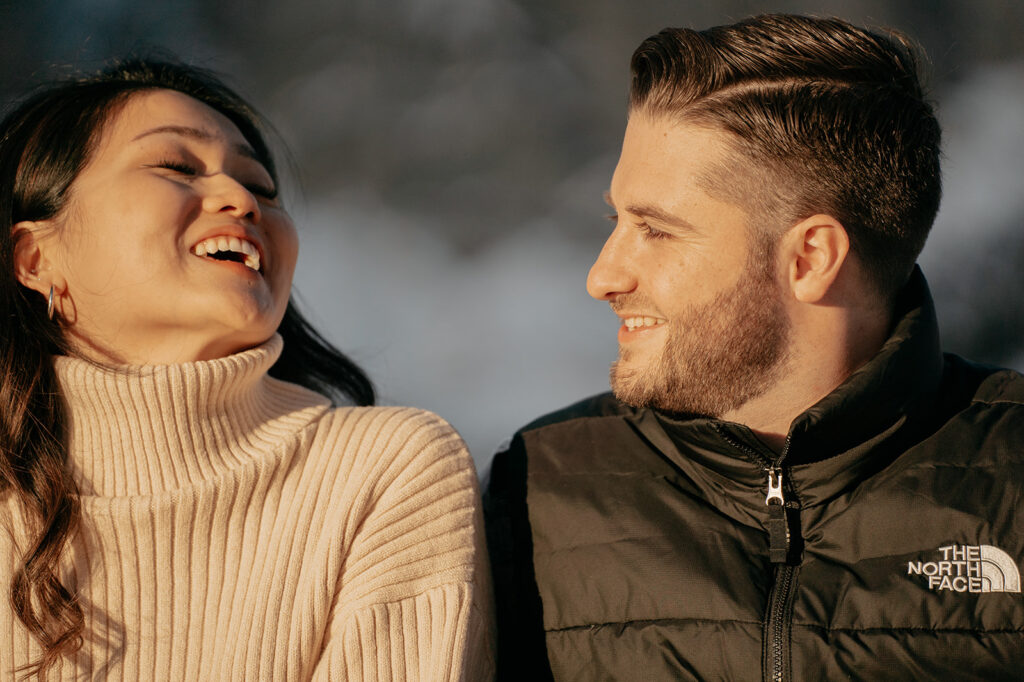 Smiling couple enjoying outdoor winter scene.