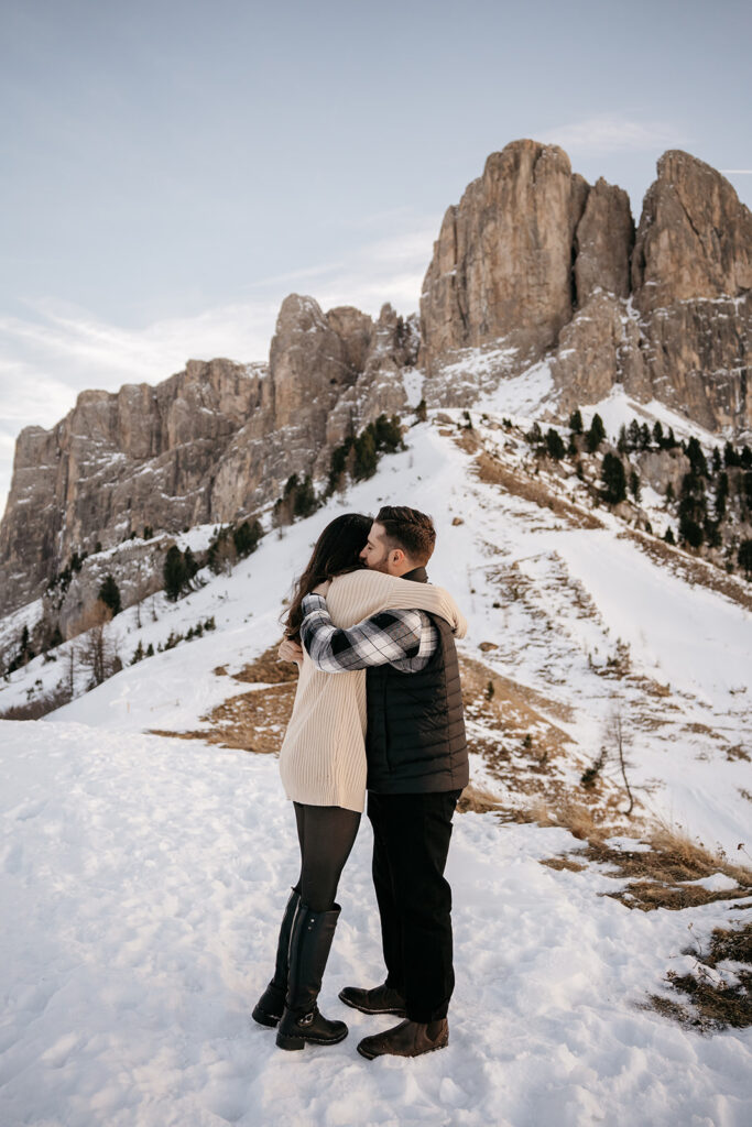 Couple embracing in snowy mountain landscape