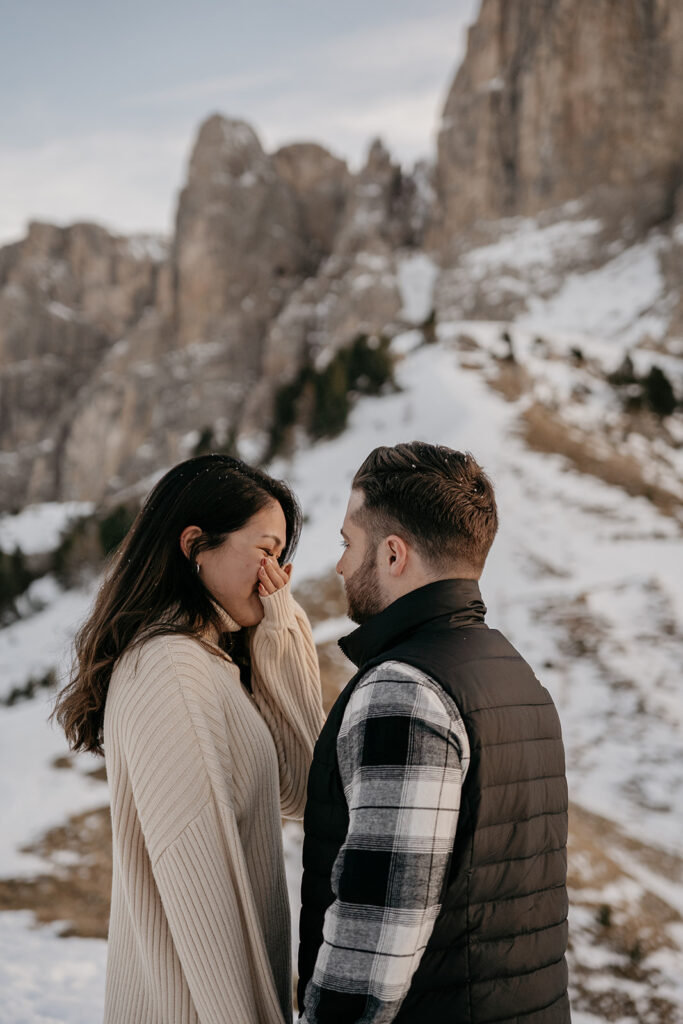 Couple enjoys snowy mountain scenery together.