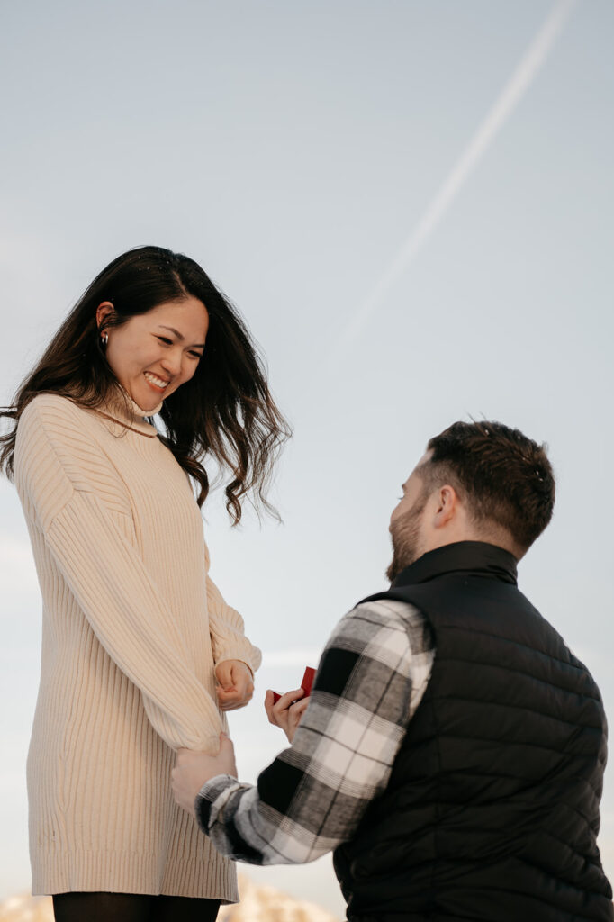 Man proposing marriage with ring outdoors