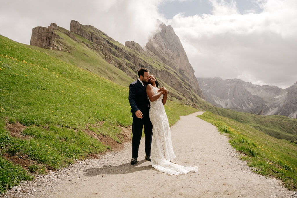 Couple celebrates wedding in scenic mountain trail.