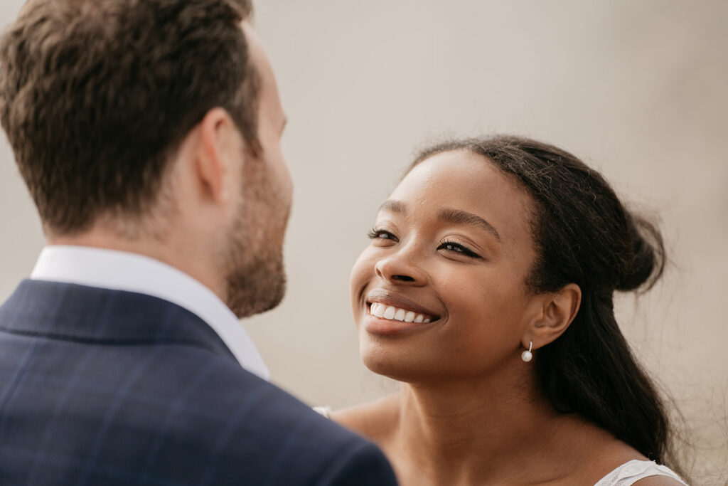 Smiling woman looking at man in suit.