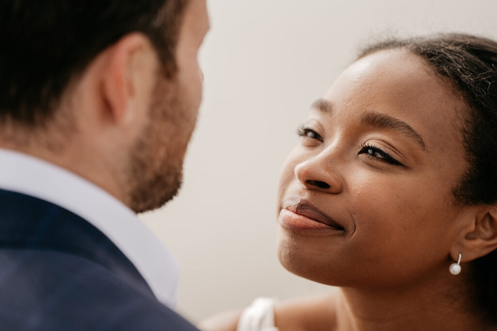 Smiling woman gazing at man, close-up view.