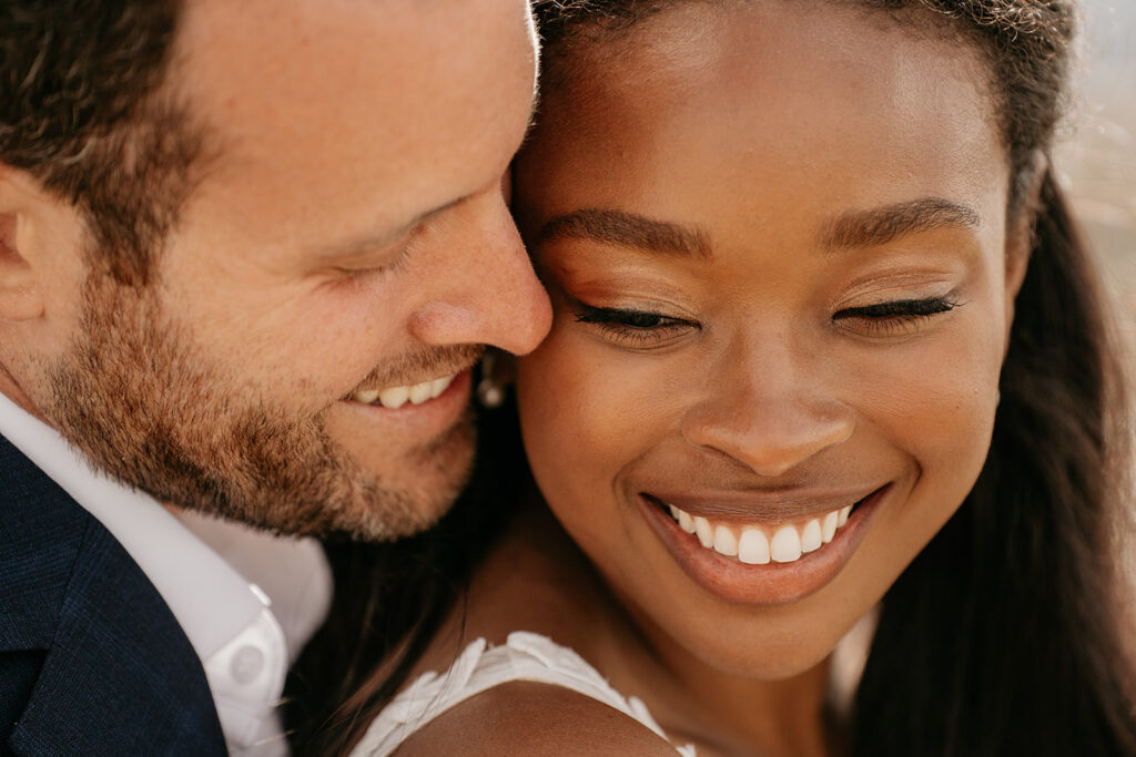 Happy couple embracing and smiling lovingly.