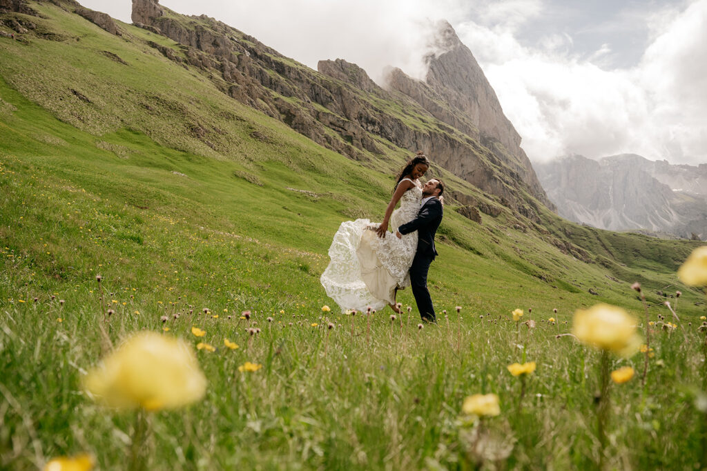 Bride and groom in mountain meadow