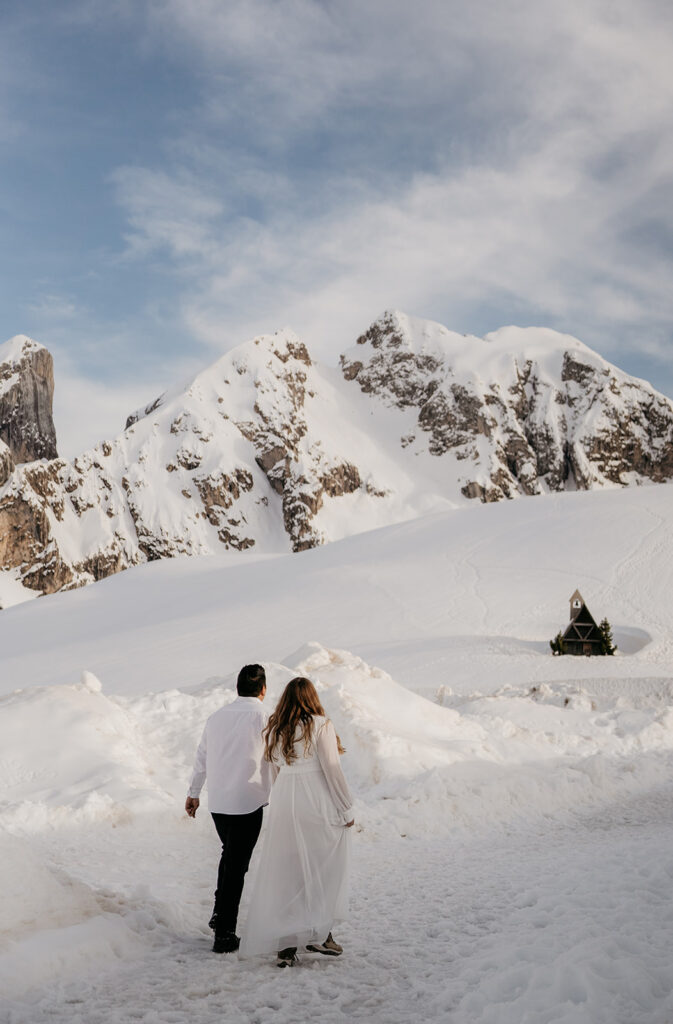 Couple walking in snowy mountain landscape