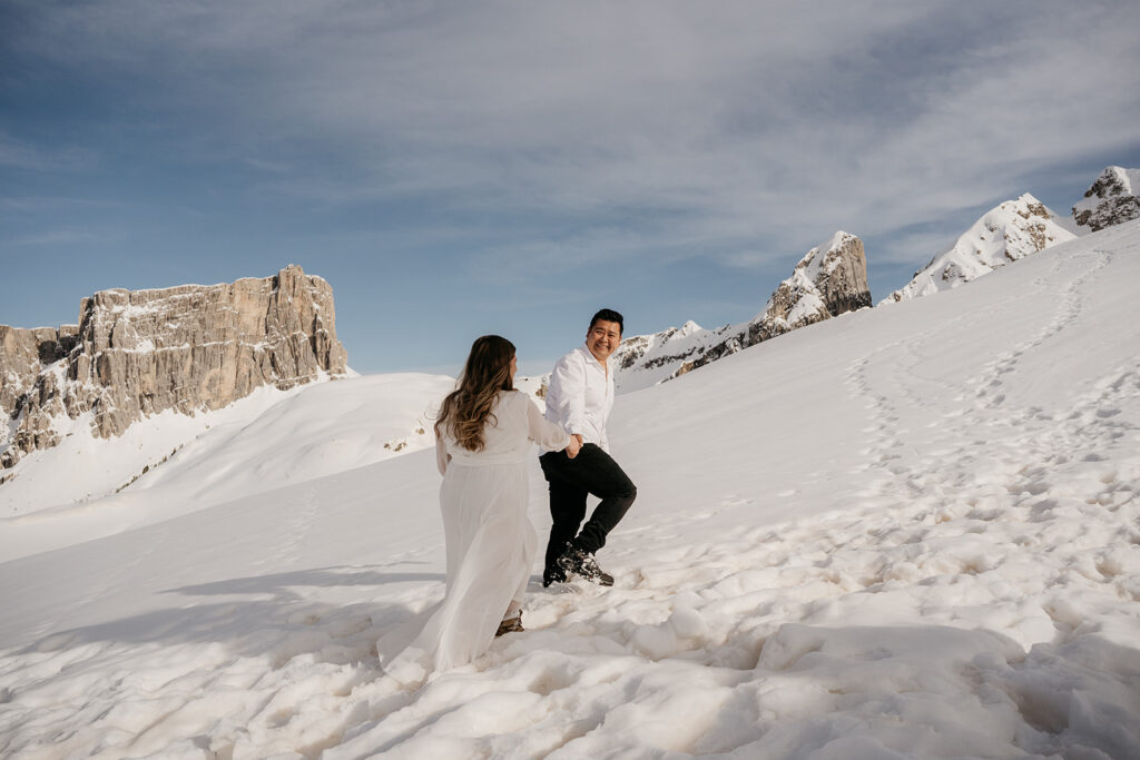 Couple walking on snowy mountain landscape