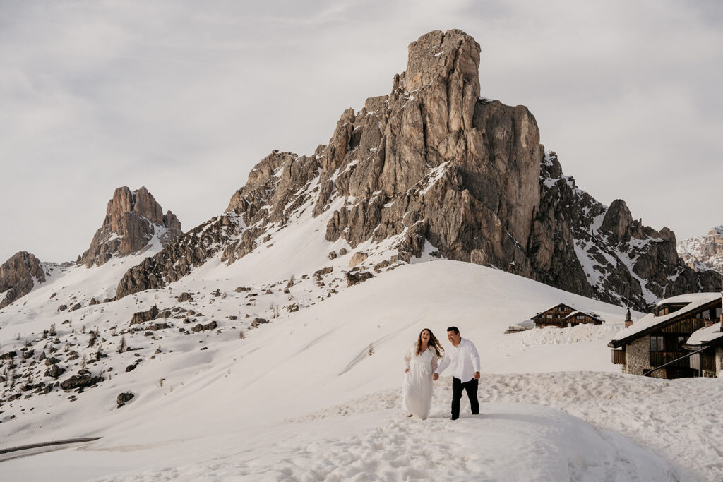 Couple walking in snowy mountain landscape