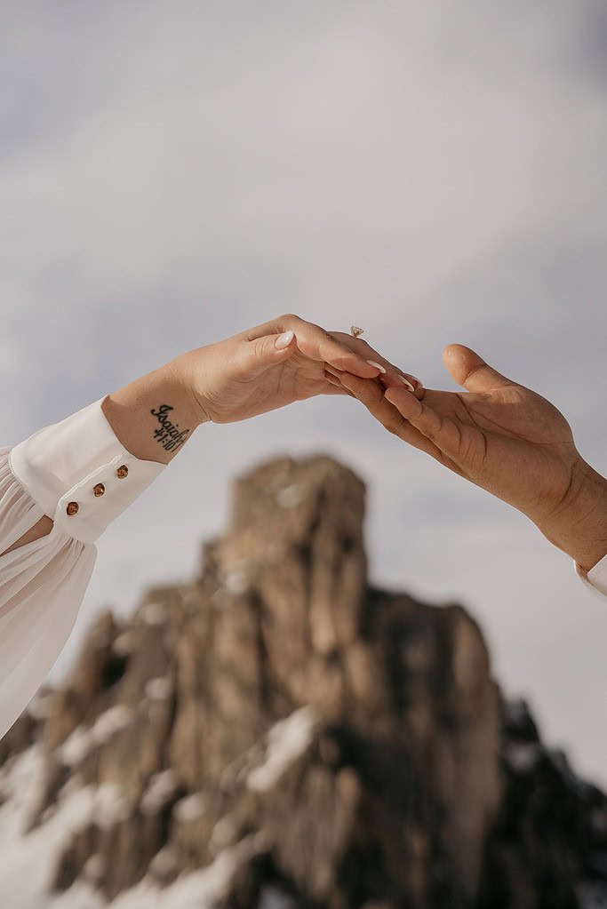 Hands reaching with mountain background