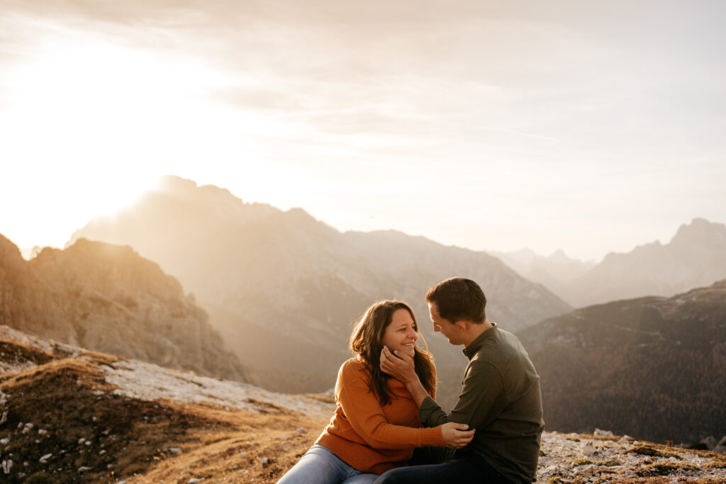 Couple smiling during mountain sunset.