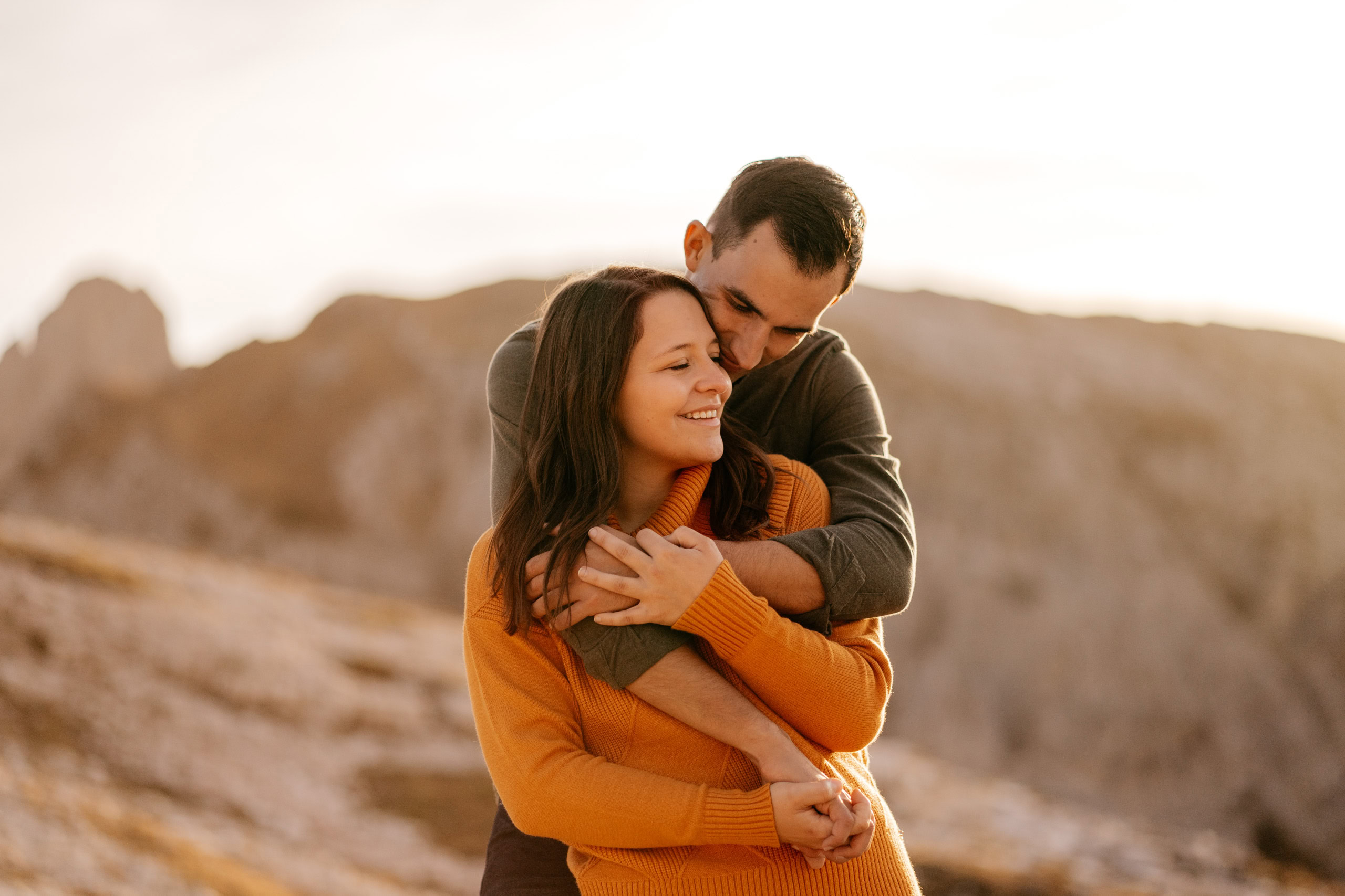 Couple embracing in scenic mountain landscape