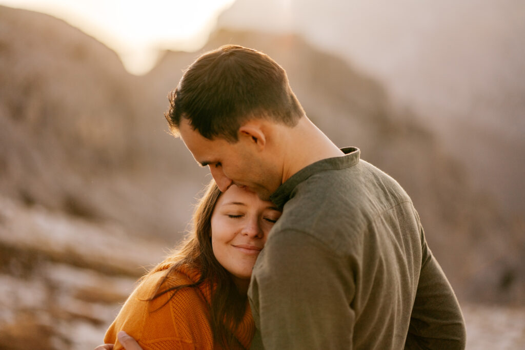 Couple embracing in a serene landscape