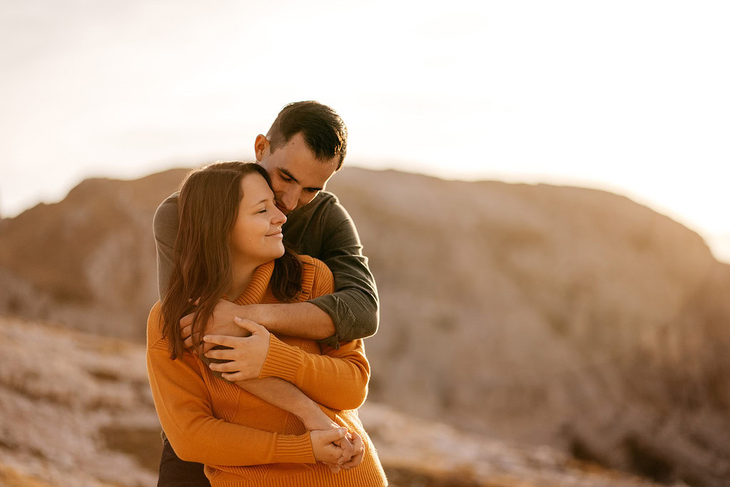 Couple embracing outdoors at sunset