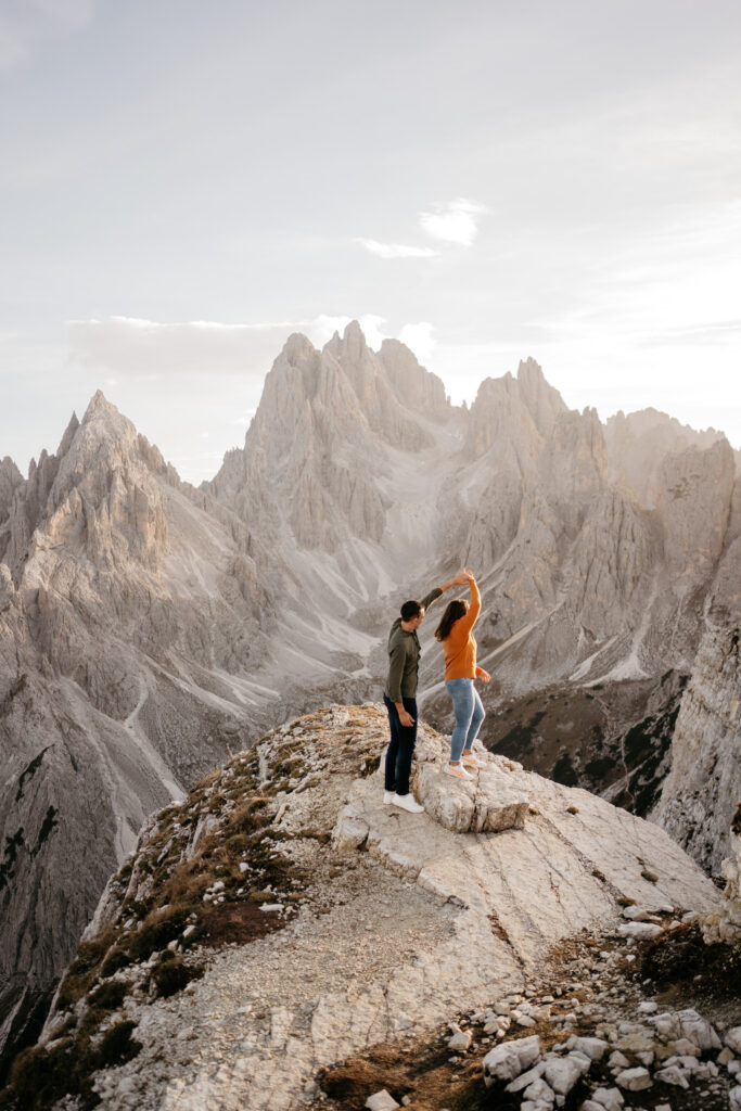 Couple dances atop scenic mountain peak