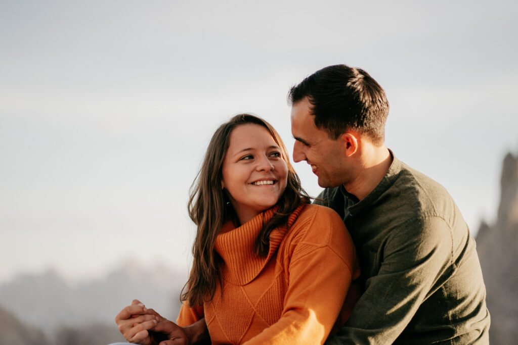 Smiling couple embracing outdoors, autumn setting